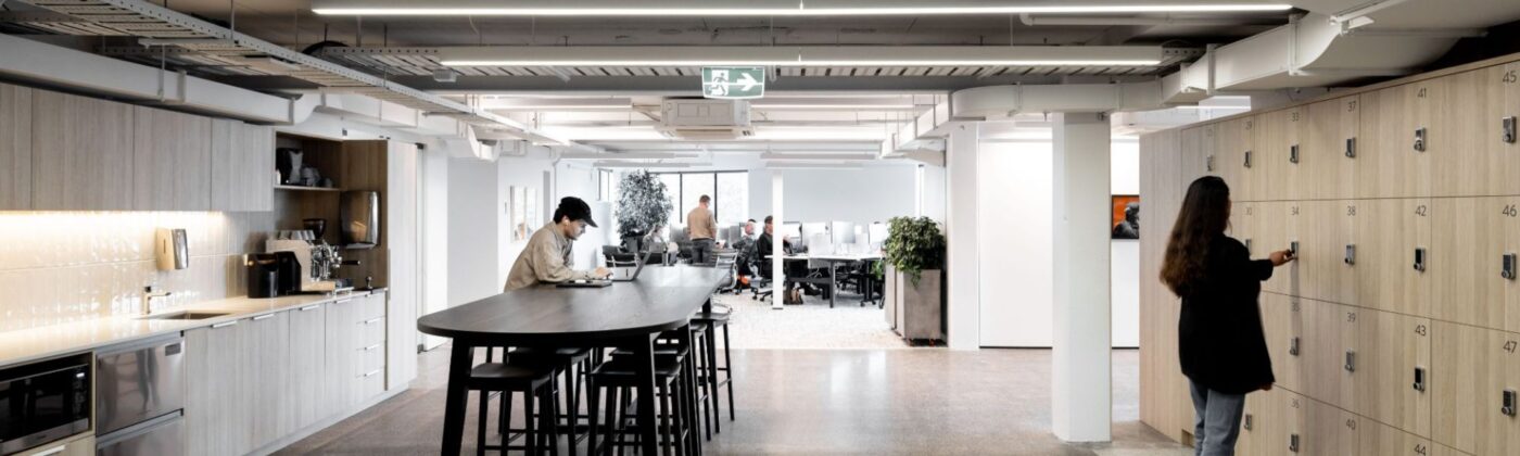 Modern open-plan office with kitchen and lockers