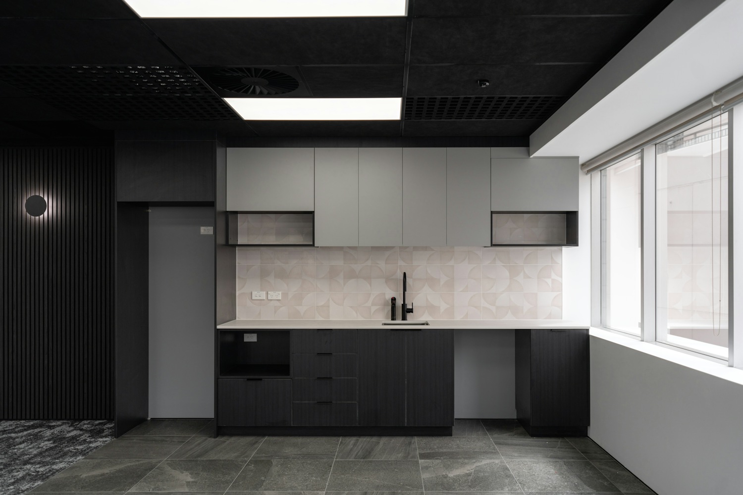 Modern minimalist kitchen with dark cabinetry and tiles