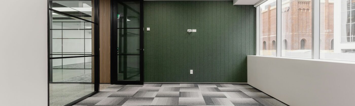 Modern empty office with glass walls and carpet