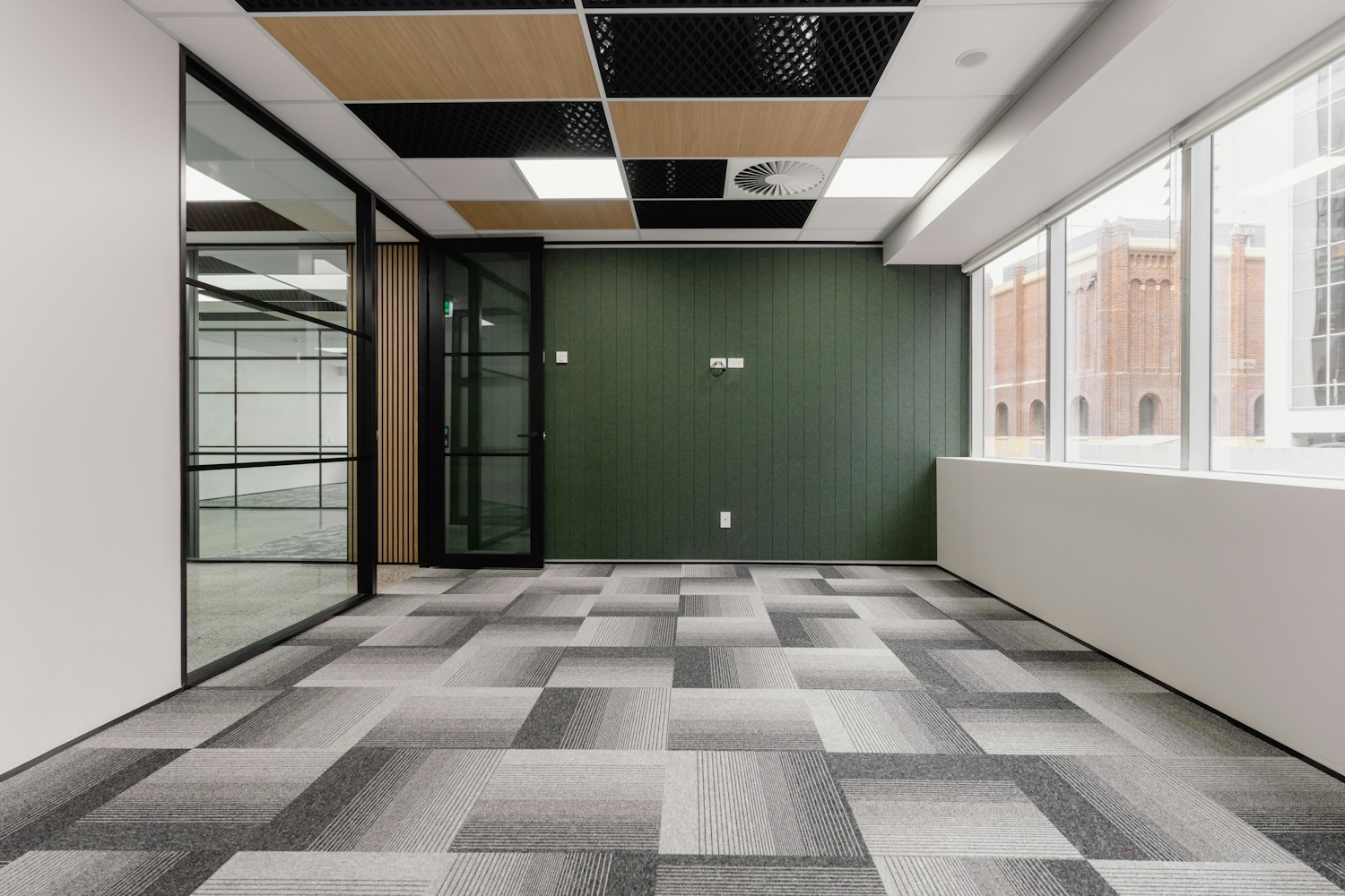 Modern empty office with glass walls and carpet