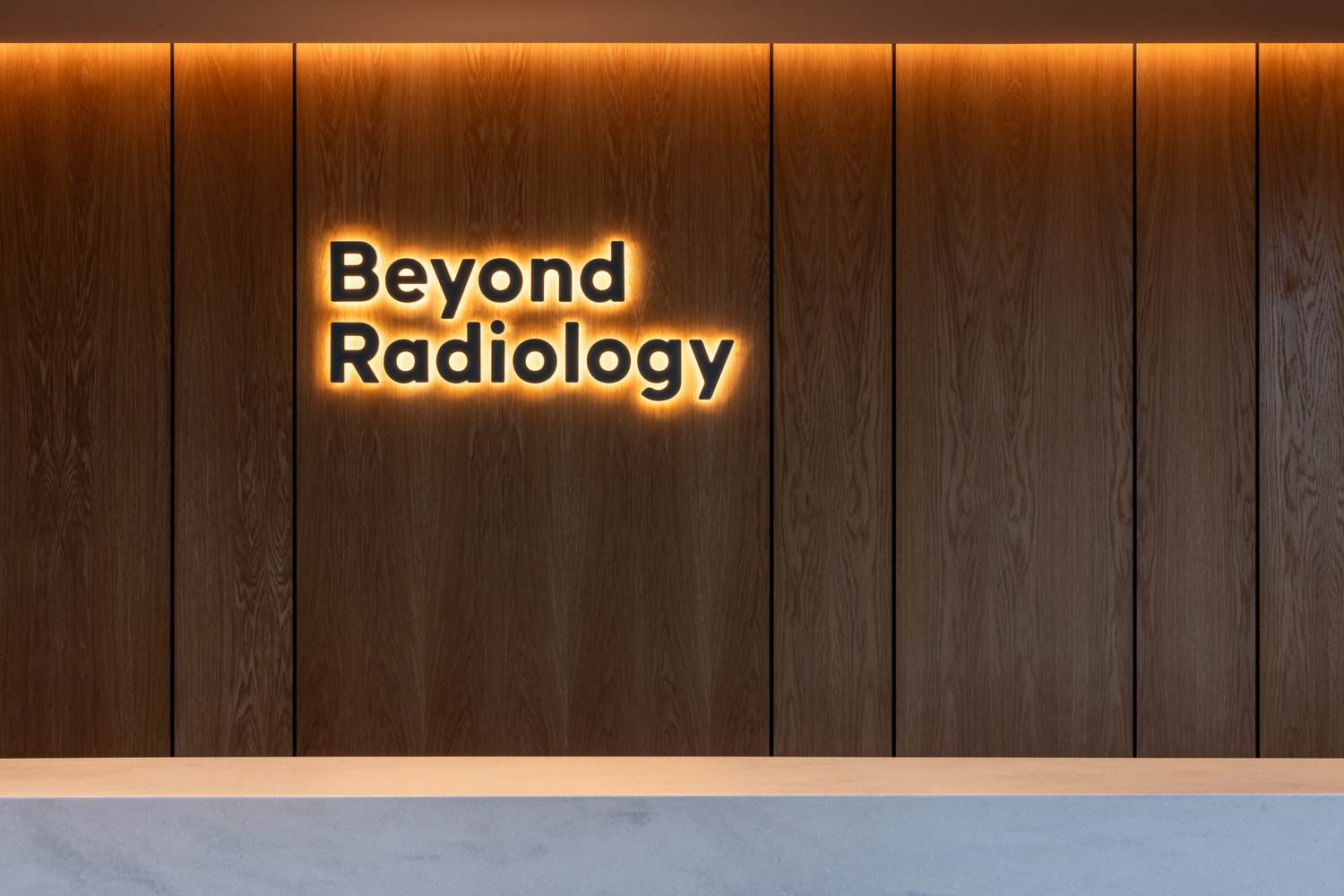 Beyond Radiology illuminated sign on wooden wall