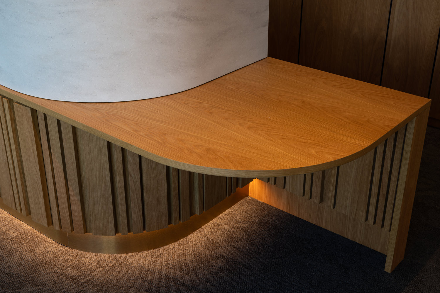 Modern wooden reception desk with curved design