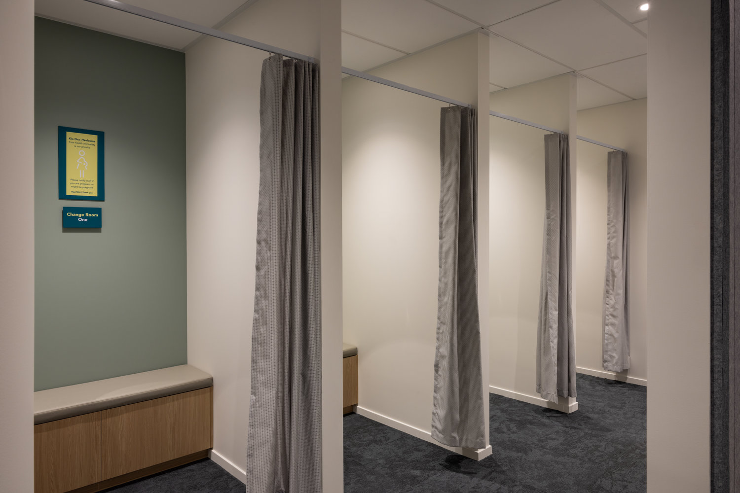 Modern change rooms with grey curtains and benches
