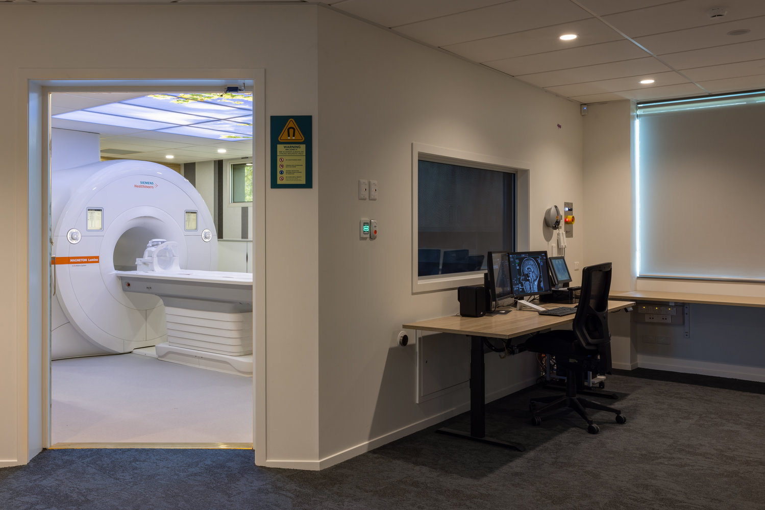 MRI scanner and control room in medical facility