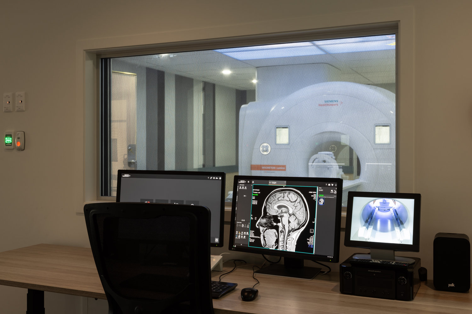 MRI control room with brain scan monitors