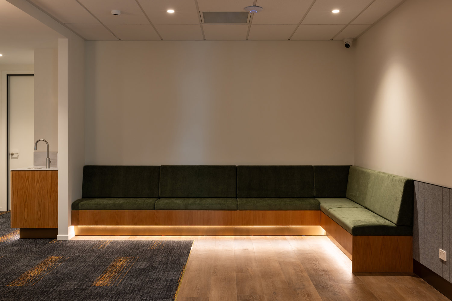 Modern waiting room with corner seating and lighting