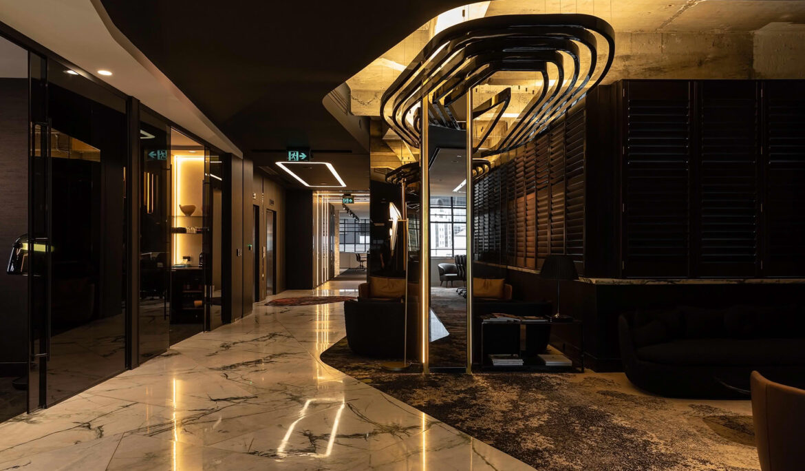 Modern hotel lobby with marble floors and lighting