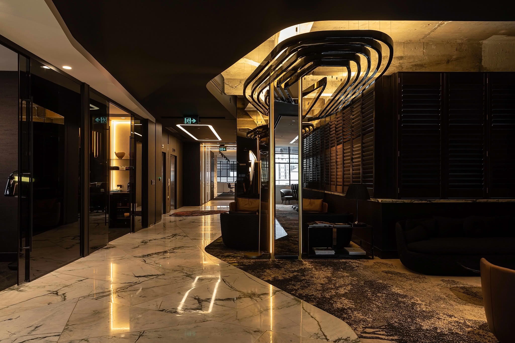 Modern hotel lobby with marble floors and lighting
