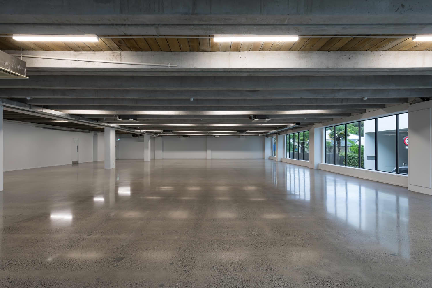 Empty modern warehouse with polished concrete floor