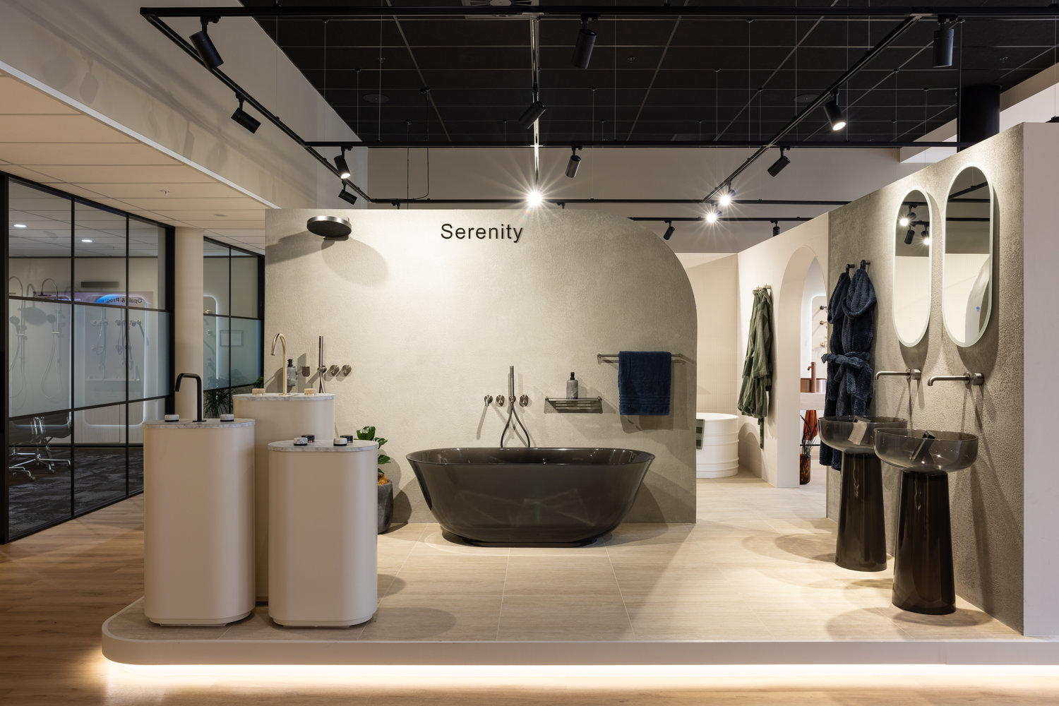 Modern bathroom showroom with black bathtub and sinks