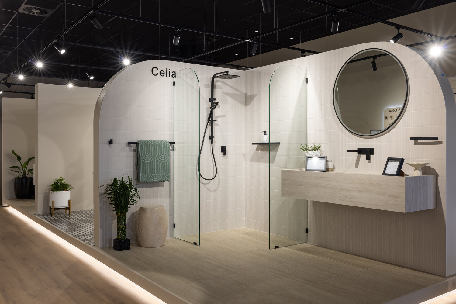 Modern bathroom with glass shower and round mirror