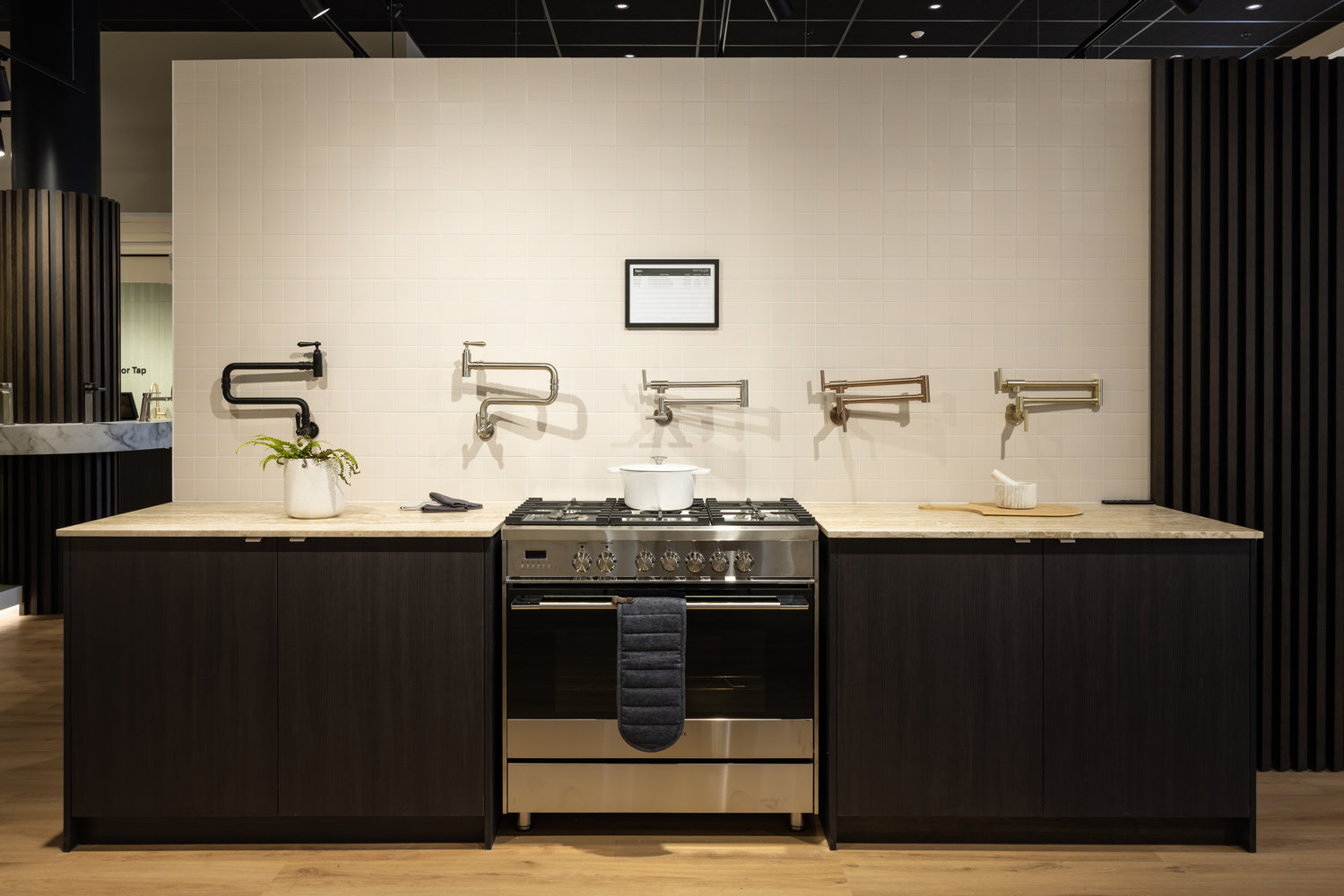 Modern kitchen display with stove and wall taps