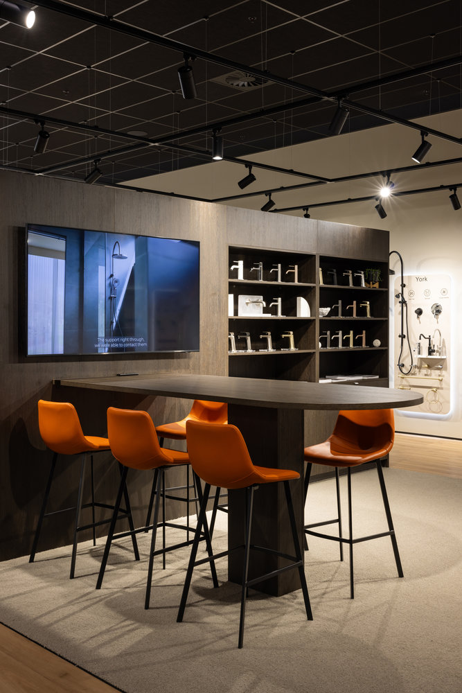 Modern showroom with orange chairs and tap displays