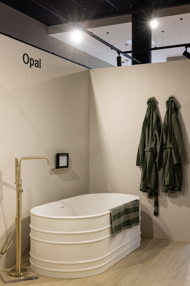Modern bathroom with white tub and gold tap