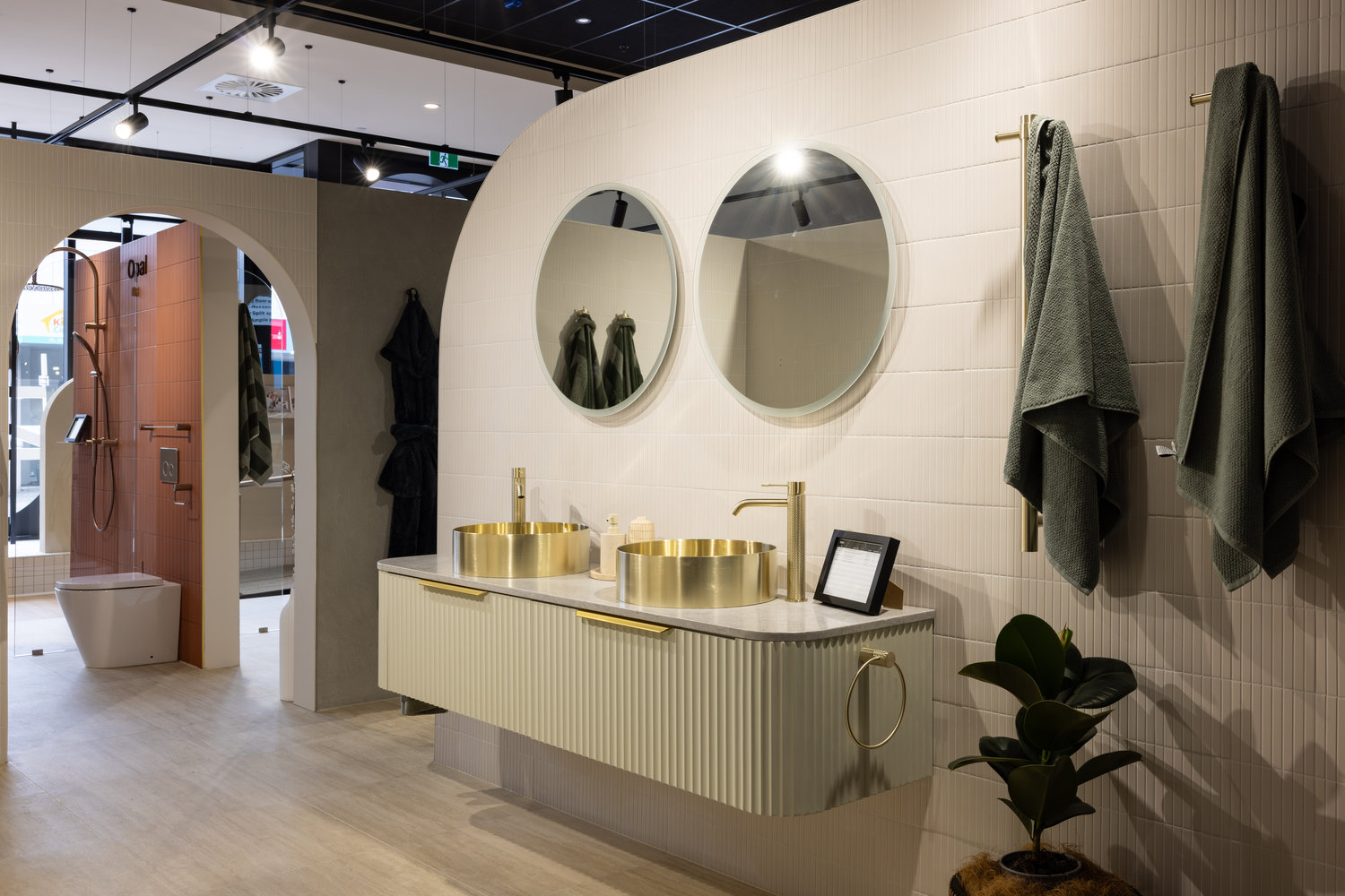 Modern bathroom with gold fixtures and double mirrors
