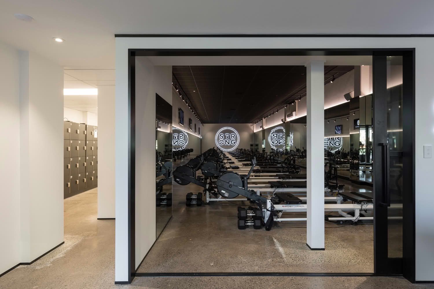 Modern gym with rowing machines and lockers