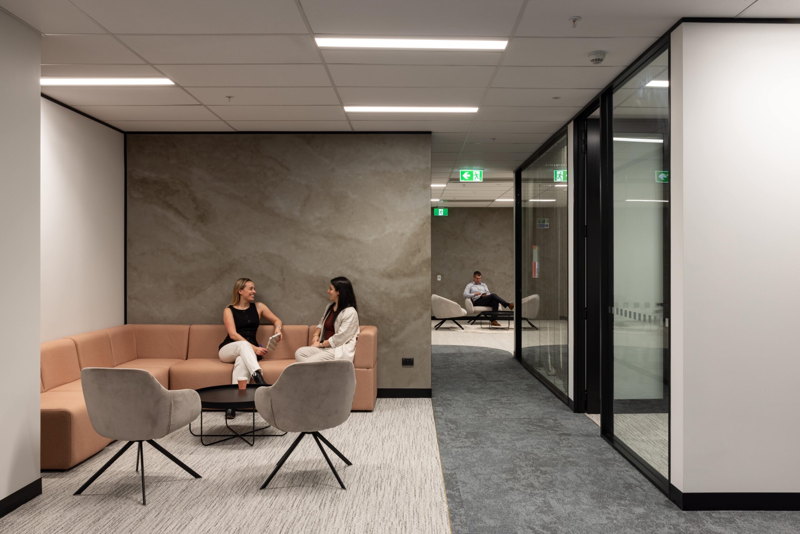 Modern office lounge with people talking