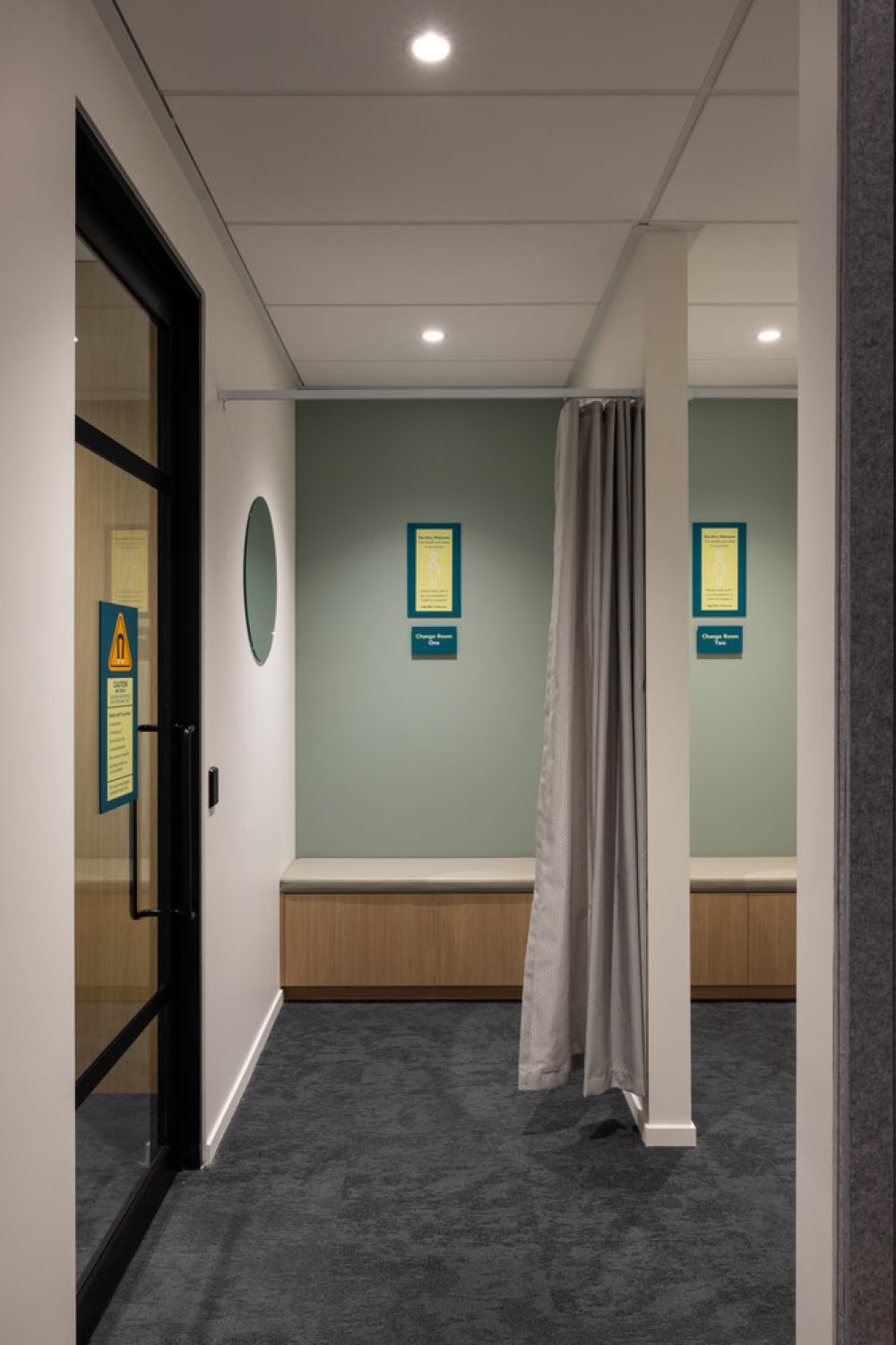 Modern changing room with curtain and seating bench
