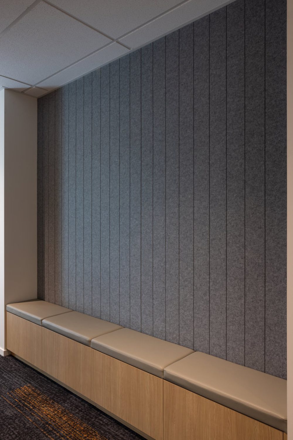 Modern hallway bench with grey acoustic wall panels